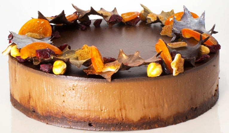 A whole Chocolate Delice Cake decorated in autumnal colours.