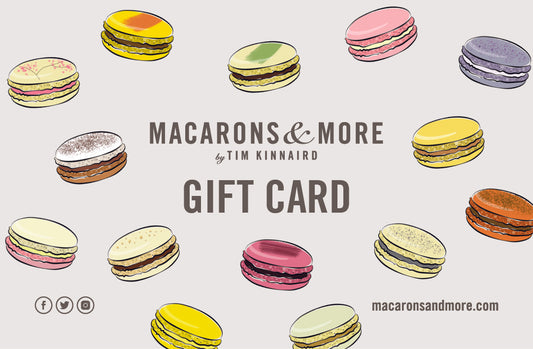 A credit card style card with the Macarons & More logo and words Gift Card written on it, surrounded by small floating macarons.